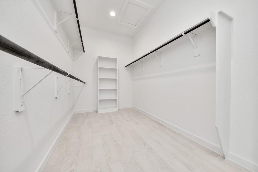 Walk-in closet that epitomizes luxury and practicality. This generously sized space features built-in shelving, offering abundant room for impeccable organization. High ceilings and recessed lighting create a bright and welcoming ambiance. Walk-in closet that epitomizes luxury and practicality. This generously sized space features built-in shelving, offering abundant room for impeccable organization. High ceilings and recessed lighting create a bright and welcoming ambiance.