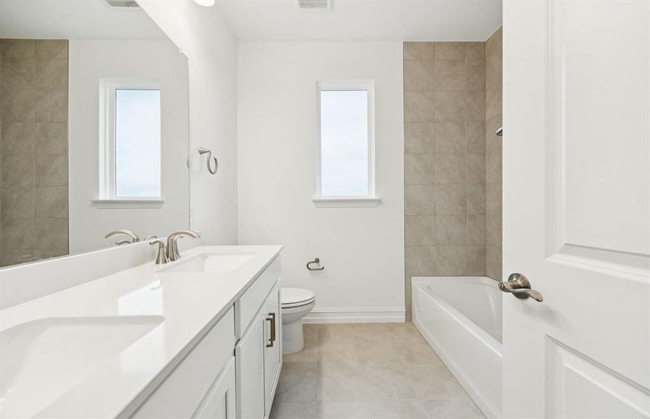 Secondary bathroom with double vanity and premium finishes