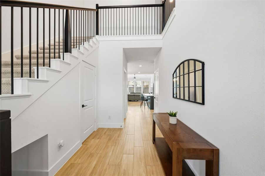 Step into a warm and welcoming two-story entry, where beautiful hardwood tile floors add character and set an inviting tone for the home. Step into a warm and welcoming two-story entry, where beautiful hardwood tile floors add character and set an inviting tone for the home.