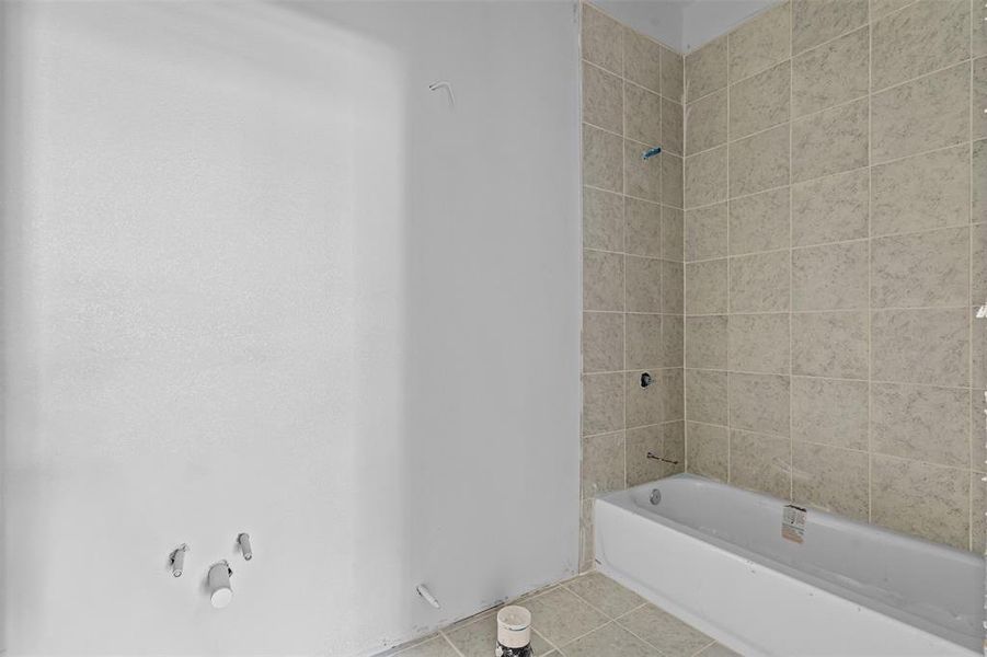 Full bathroom with tile patterned flooring and shower / bath combination Full bathroom with tile patterned flooring and shower / bath combination