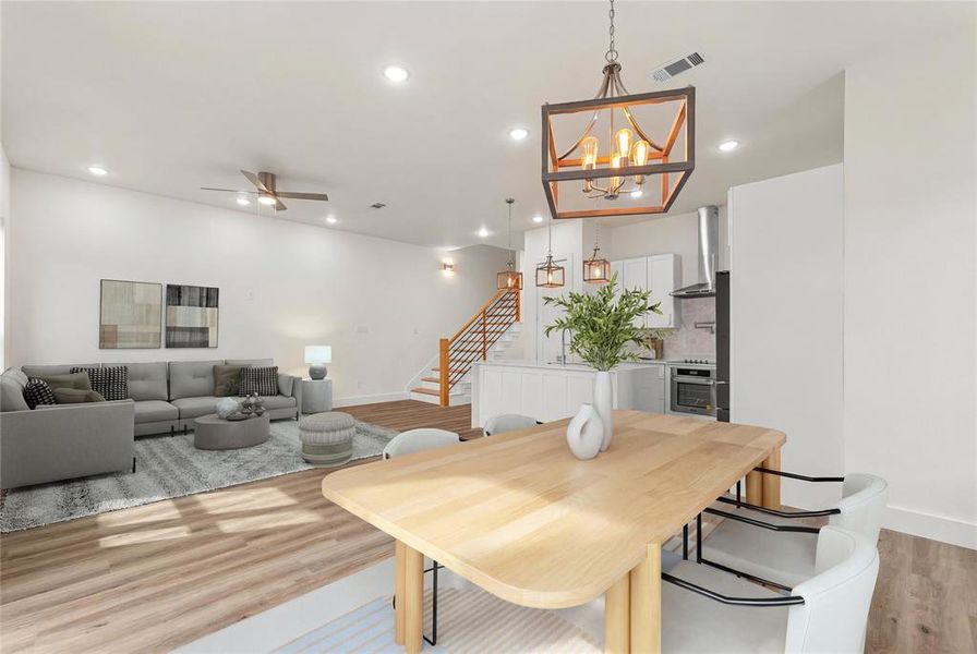 Dining area with stairway, light wood-type flooring, recessed lighting, ceiling fan, and a chandelier