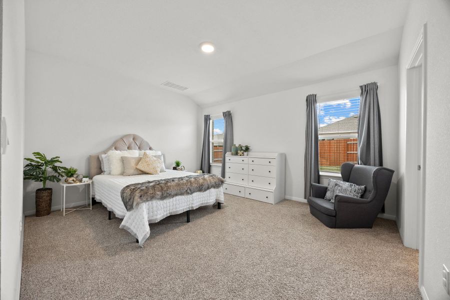 Bedroom featuring light colored carpet, lofted ceiling, and recessed lighting