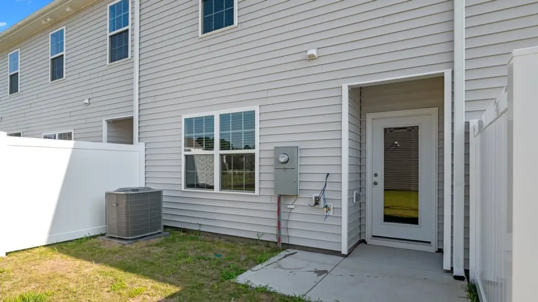 Exterior details and patio area of a home in The Townes at Ridgewood Farms, Winterville (Image 21).