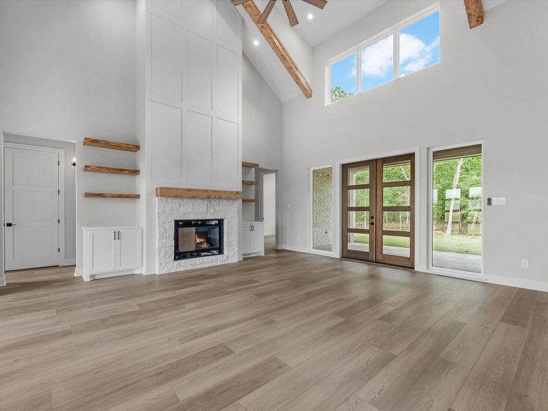Grand front entry with double glass doors, soaring ceilings, and abundant natural light creating a warm first impression.