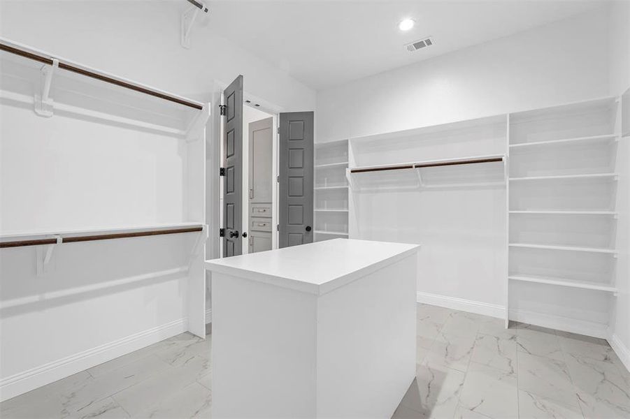 Walk in closet featuring light tile floors