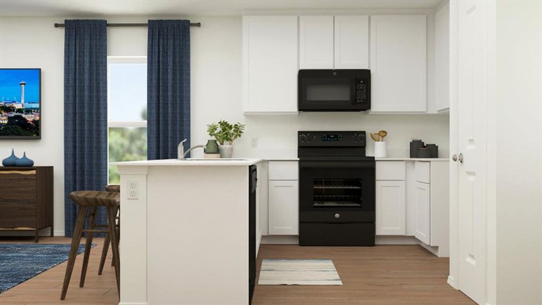 Kitchen featuring a breakfast bar area, light countertops, white cabinetry, a peninsula, and black appliances