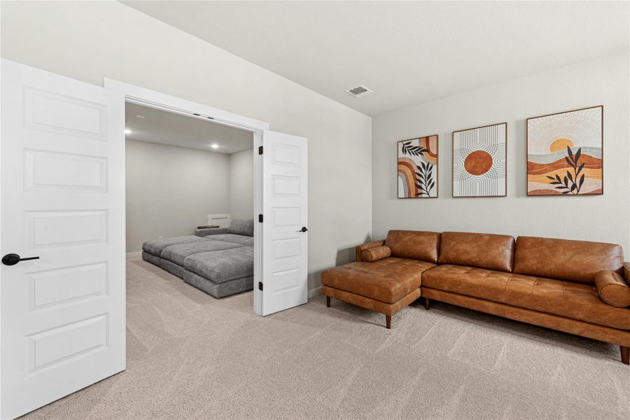 Living area with light colored carpet and baseboards