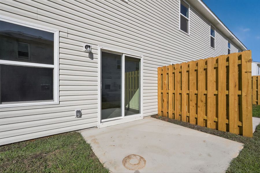 A white house with a wood fence.