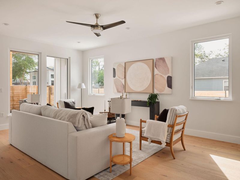 Living room with light wood-style flooring, a ceiling fan, and recessed lighting Living room with light wood-style flooring, a ceiling fan, and recessed lighting