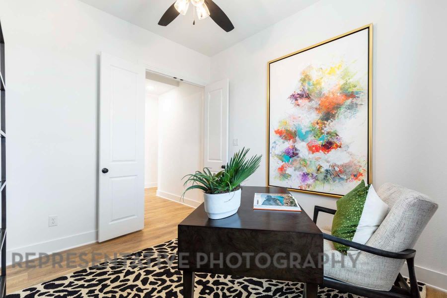 Home office featuring a ceiling fan, baseboards, and light wood-style floors Home office featuring a ceiling fan, baseboards, and light wood-style floors