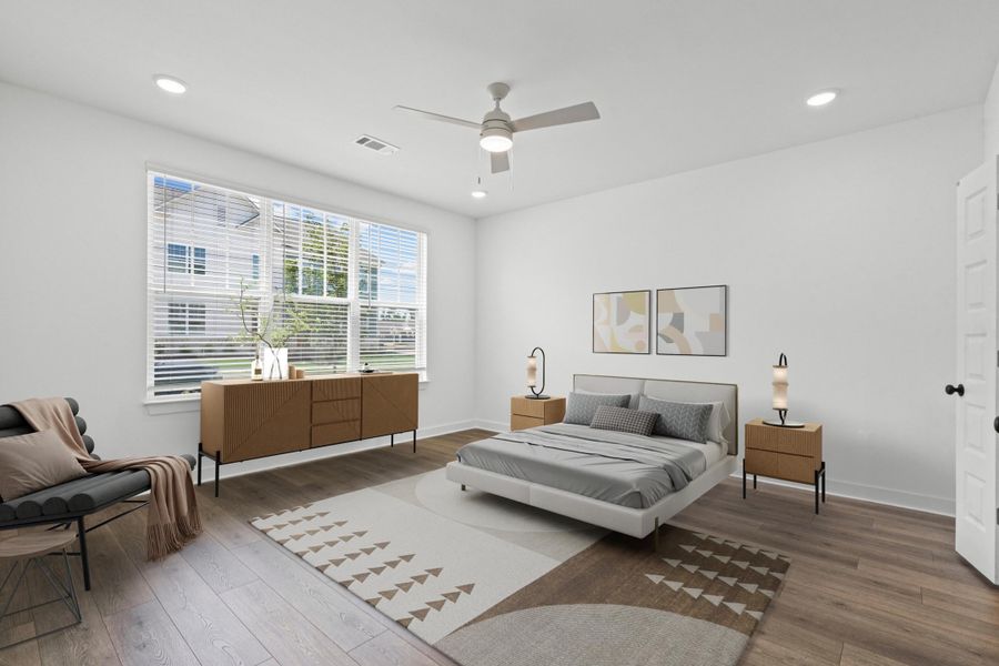 Spacious room featuring wood-finish flooring, white walls, and a large window with blinds