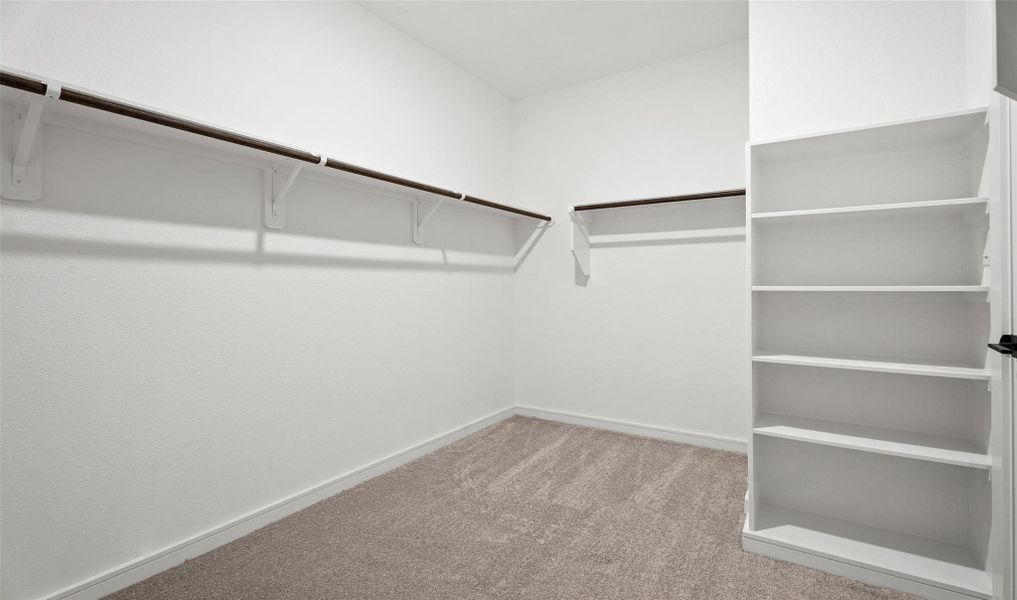 Walk-in closet in primary suite (*Photo not of actual home and used for illustration purposes only.) Walk-in closet in primary suite (*Photo not of actual home and used for illustration purposes only.)