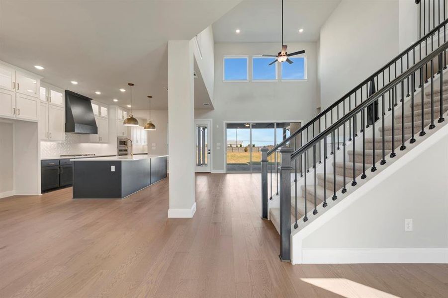 Entryway with light wood-type flooring, a high ceiling, recessed lighting, and ceiling fan Entryway with light wood-type flooring, a high ceiling, recessed lighting, and ceiling fan