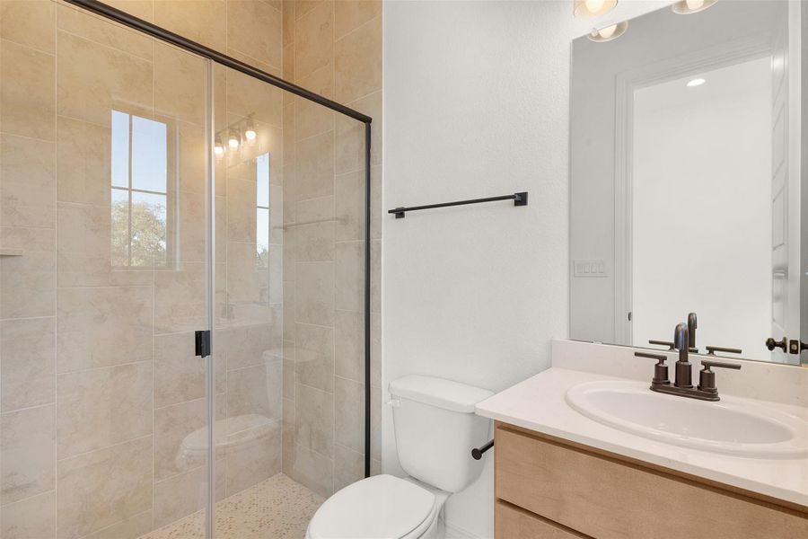 Full bathroom with vanity and a shower stall