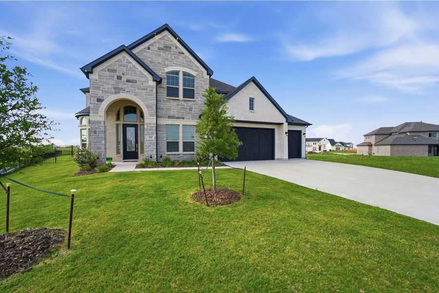 Front exterior of a new home in Heath Golf & Yacht Club, Heath, TX, highlighting curb appeal (Image 2). Front exterior of a new home in Heath Golf & Yacht Club, Heath, TX, highlighting curb appeal (Image 2).