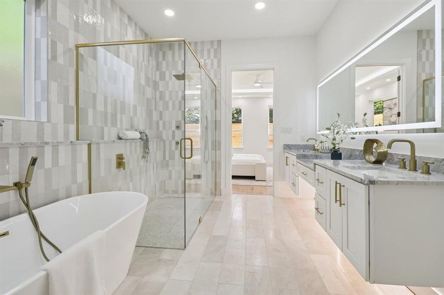 Bathroom with a soaking tub, double vanity, ensuite bath, ceiling fan, and a shower stall