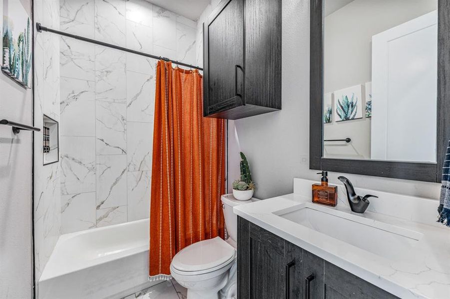 Bathroom with shower / bath combo and vanity
