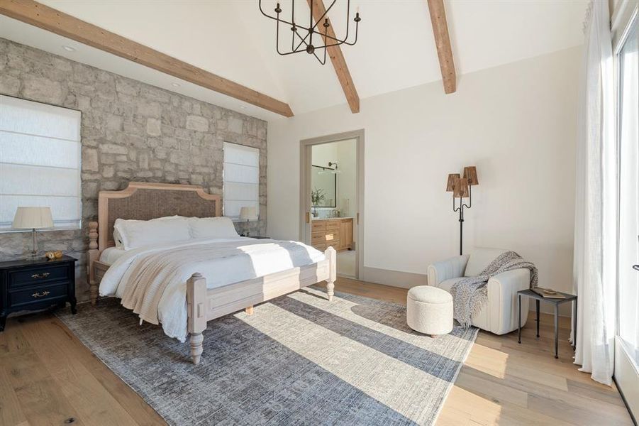 Bedroom with a notable chandelier, ensuite bathroom, beam ceiling, and light hardwood / wood-style flooring