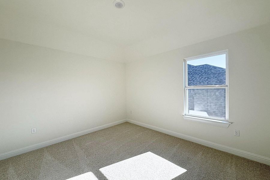 Carpeted spare room with baseboards