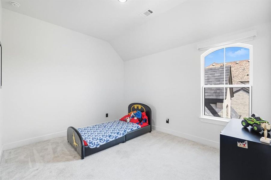 Upstairs carpeted bedroom featuring lofted ceiling, ensuite bathroom & walk-in closet (located next to the updstairs half bath) Upstairs carpeted bedroom featuring lofted ceiling, ensuite bathroom & walk-in closet (located next to the updstairs half bath)