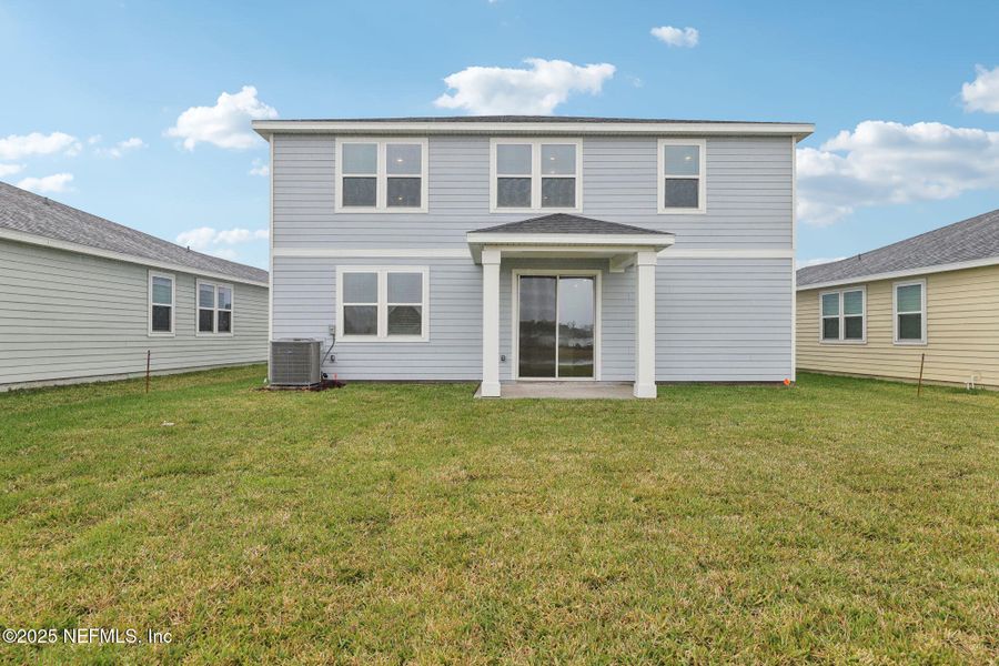 Front exterior of a new home in Lakes at Bella Lago - Signature Series, Green Cove Springs, FL, highlighting curb appeal (Image 20). Front exterior of a new home in Lakes at Bella Lago - Signature Series, Green Cove Springs, FL, highlighting curb appeal (Image 20).