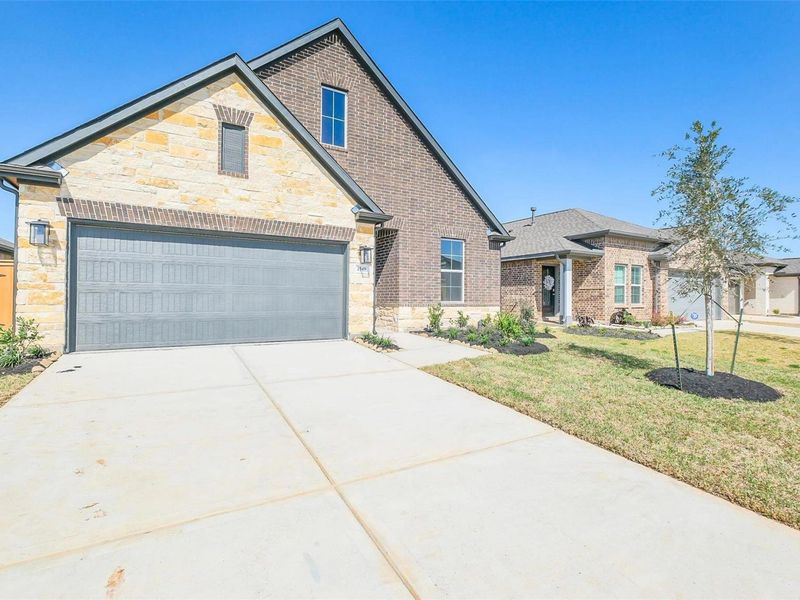 Front exterior of a new home in Sunterra, Katy, TX, highlighting curb appeal (Image 21).