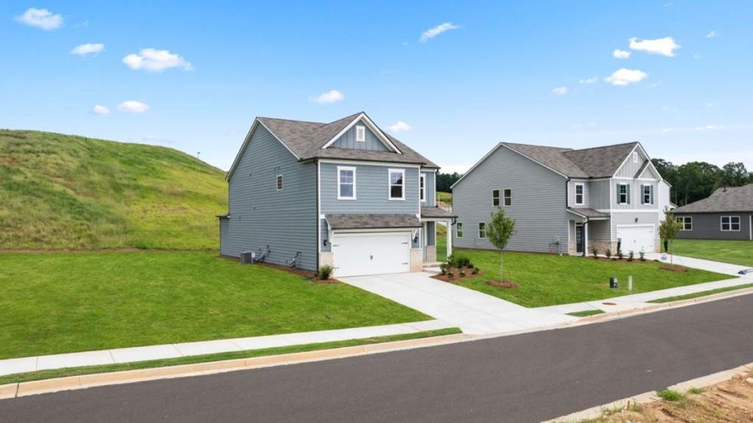 Front exterior of a new home in Sheffield Highlands, Dallas, GA, highlighting curb appeal (Image 28). Front exterior of a new home in Sheffield Highlands, Dallas, GA, highlighting curb appeal (Image 28).