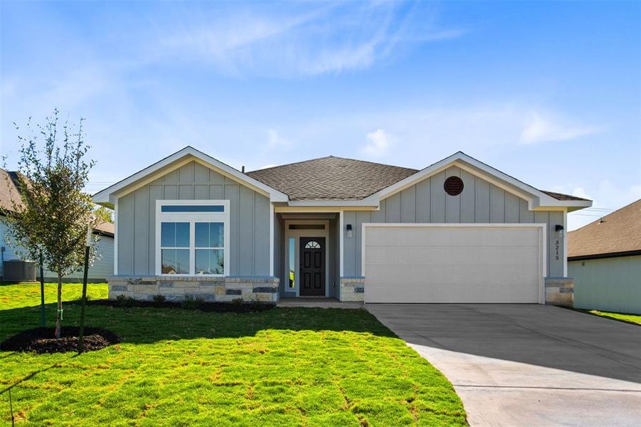 Single story home featuring a garage and concrete driveway Single story home featuring a garage and concrete driveway