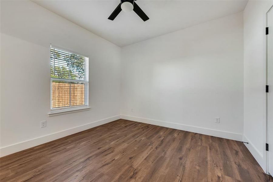 Spare room with dark wood finished floors and ceiling fan Spare room with dark wood finished floors and ceiling fan