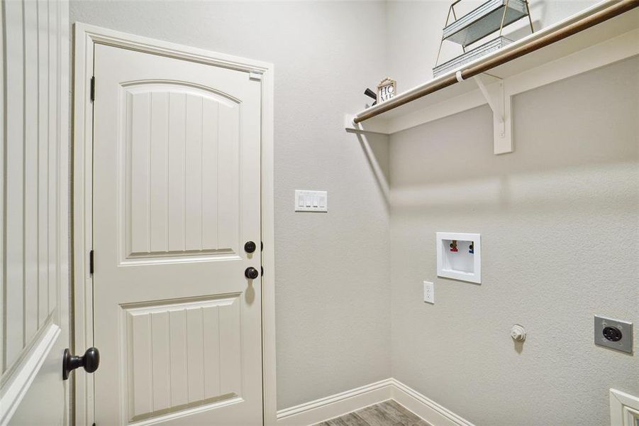 Washroom featuring electric dryer hookup, hardwood / wood-style flooring, and washer hookup