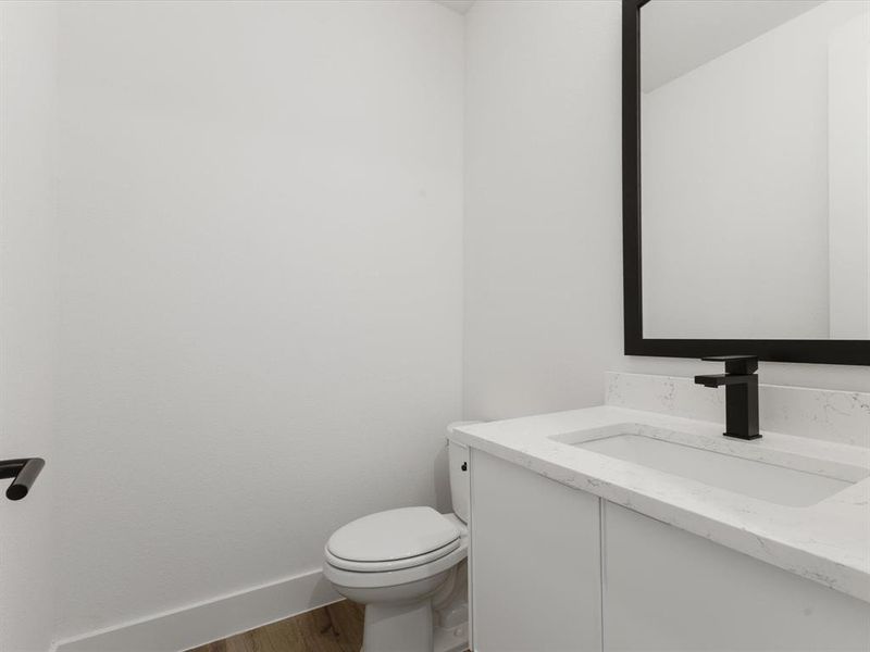 Powder Bathroom featuring vanity and wood finished floors