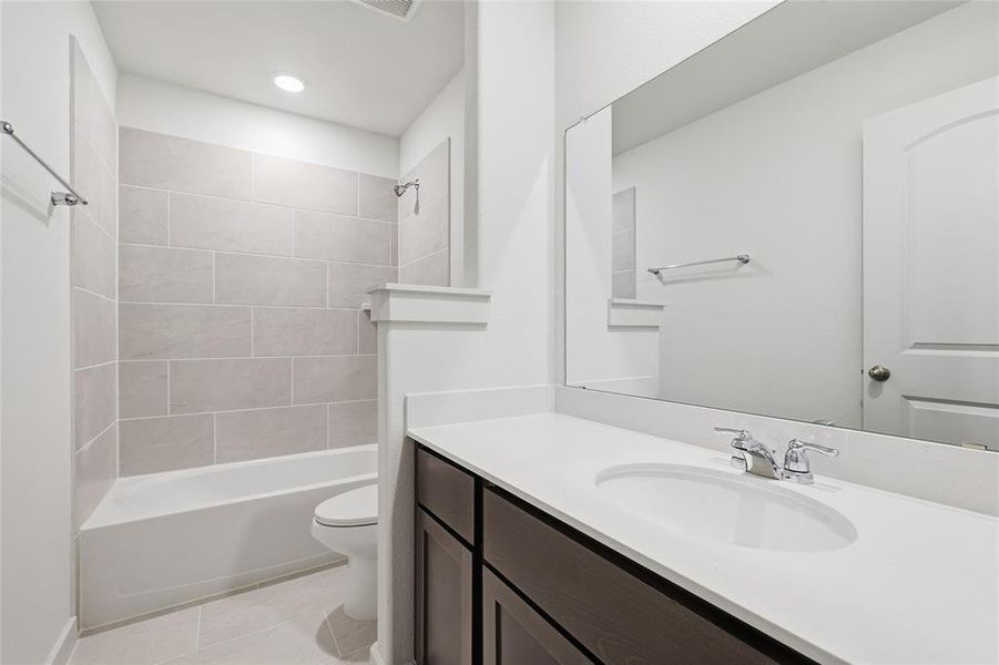 Full bath with shower / washtub combination, light tile patterned floors, vanity, and recessed lighting Full bath with shower / washtub combination, light tile patterned floors, vanity, and recessed lighting