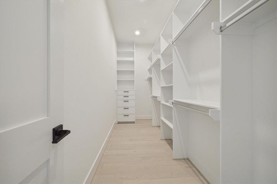 The second extra large walk-in closet is off of the primary bedroom with custom shelves and lots to drawer space!