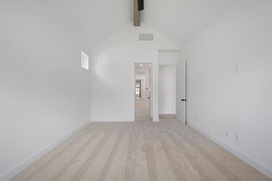 Unfurnished room featuring light carpet and baseboards