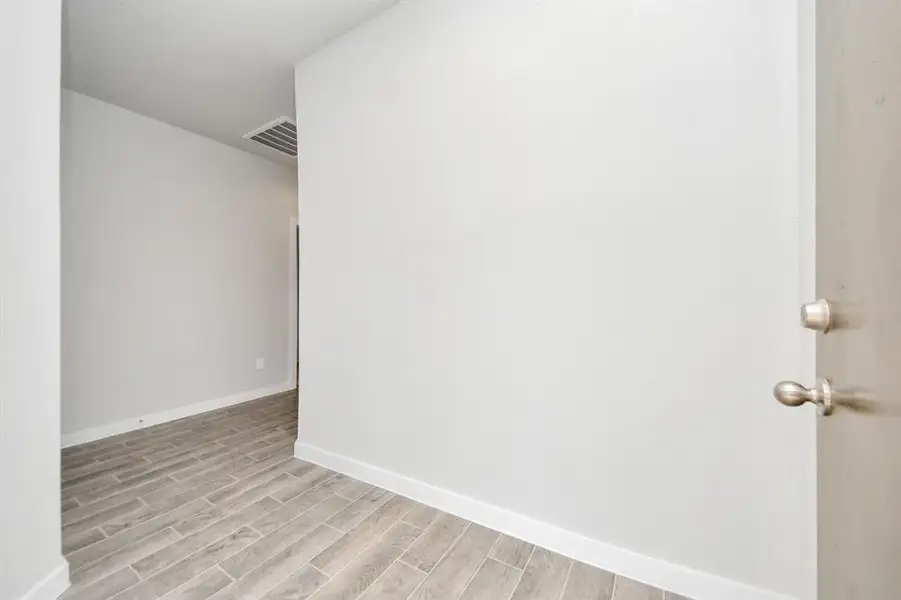 As you step into the threshold of this luxurious home, you'll soon be welcomed by an elegant glass door (to be installed). Inside, soaring ceilings amplify the spaciousness, while the refined wood-look tile flooring and oversized baseboards exude sophistication and charm.