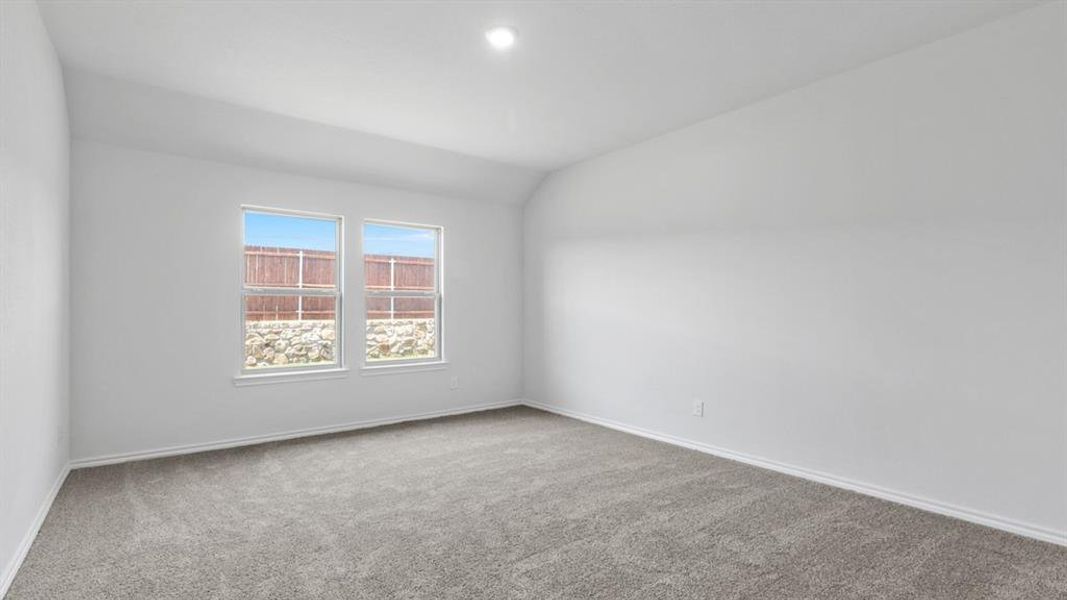 Spacious room featuring neutral carpeting, white painted walls, and two large windows with white trim