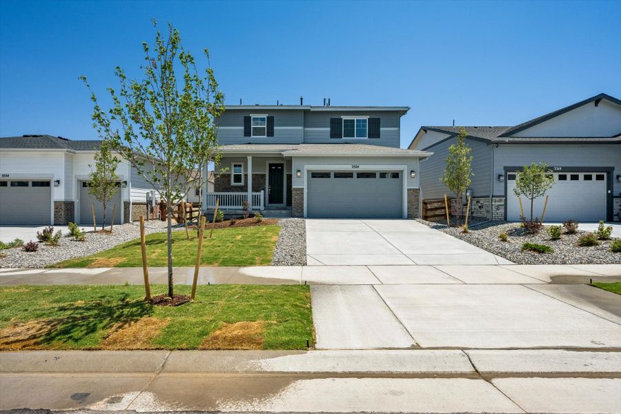 Front exterior of a new home in The Aurora Highlands, Aurora, CO, highlighting curb appeal (Image 1). Front exterior of a new home in The Aurora Highlands, Aurora, CO, highlighting curb appeal (Image 1).