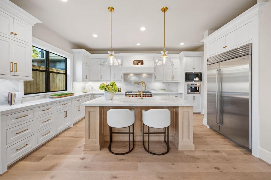 Gourmet Kitchen is equipped w/ luxury appliance package, which includes a 48in Thermador Refrigerator, 48in Gas Range w/ double oven, matching Dishwasher, built-in coffee maker & microwave. Abundant counters & cabinets offer plenty of pot/pan storage and prep space. A Large cutom site-built island w/ quartz counters anchors the Kitchen.