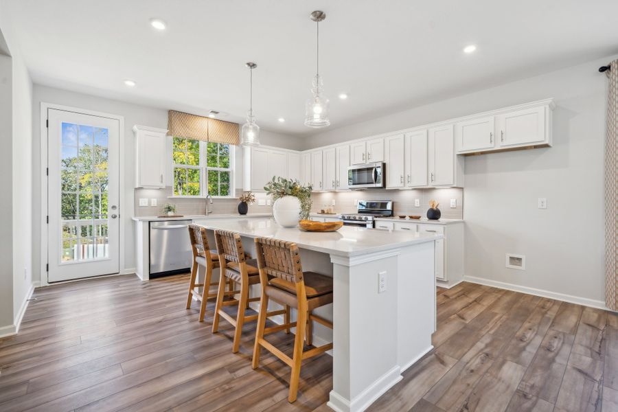 A kitchen with white cabinets.