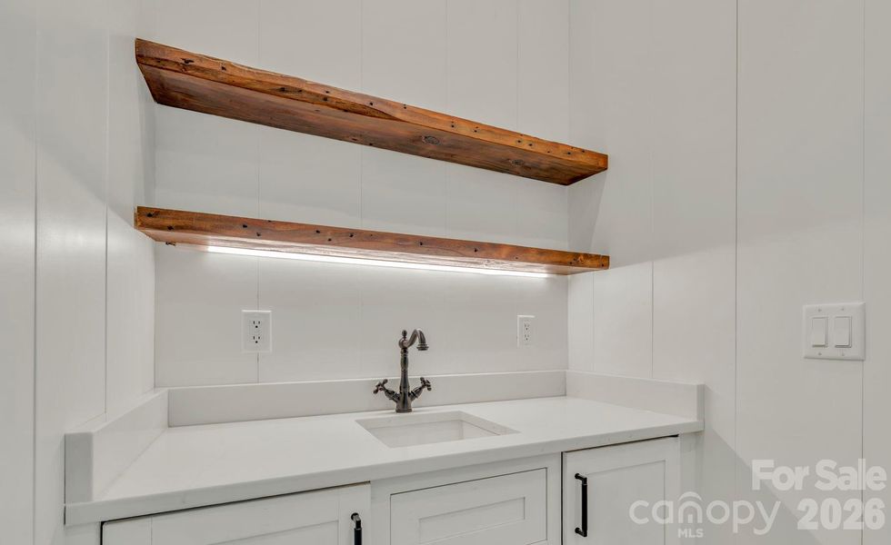 wet bar off main level living- reclaimed mantels from Green Park Inn!