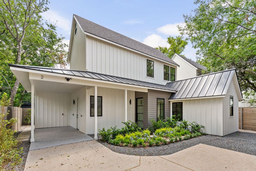 Modern farmhouse style home with board and batten siding, a porch, and driveway Modern farmhouse style home with board and batten siding, a porch, and driveway