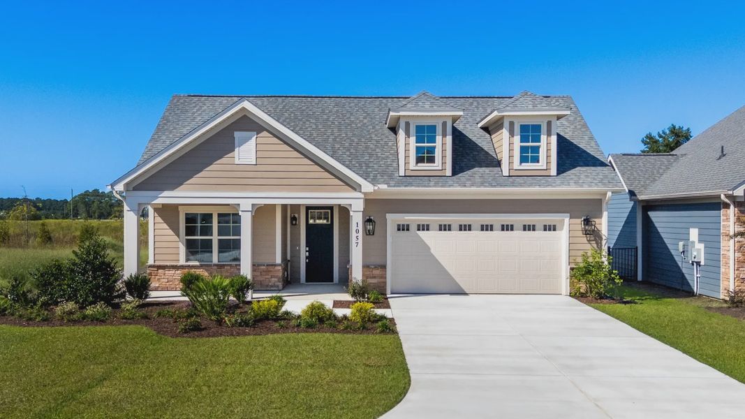 Front exterior of a new home in Courtyards by Carrell, Ocean Isle Beach, NC, highlighting curb appeal (Image 22). Front exterior of a new home in Courtyards by Carrell, Ocean Isle Beach, NC, highlighting curb appeal (Image 22).