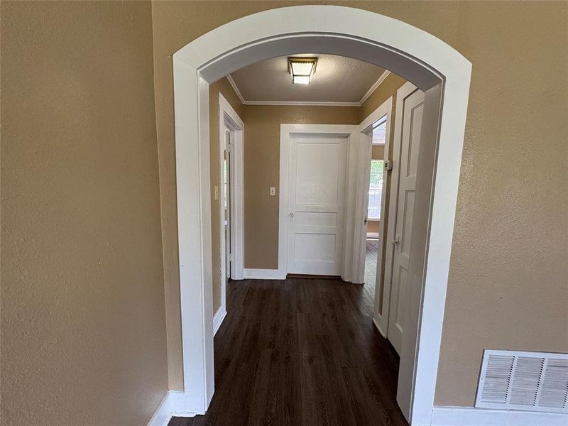 Hallway featuring arched walkway Hallway featuring arched walkway