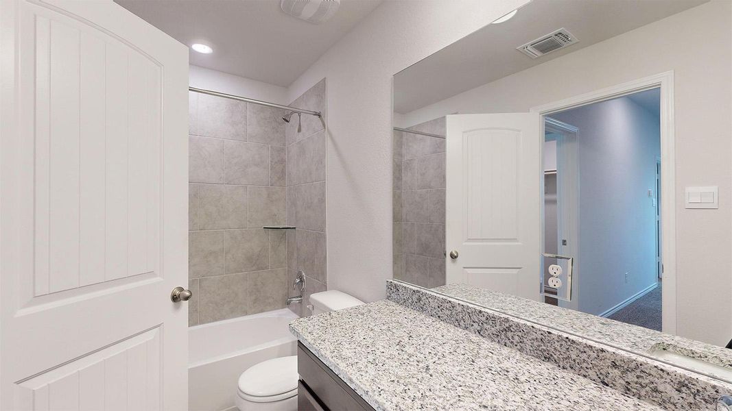 Bathroom with shower / tub combination and vanity