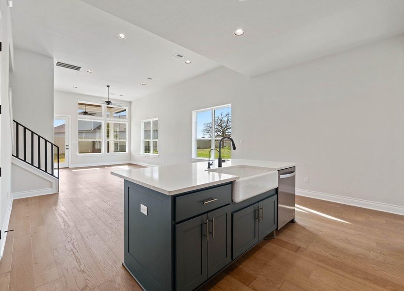 Kitchen with a sink, gray cabinetry, baseboards, dishwasher, and a ceiling fan Kitchen with a sink, gray cabinetry, baseboards, dishwasher, and a ceiling fan