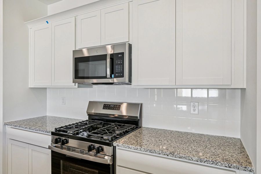 Kitchen - Chic white finishes and smooth surfaces shine.