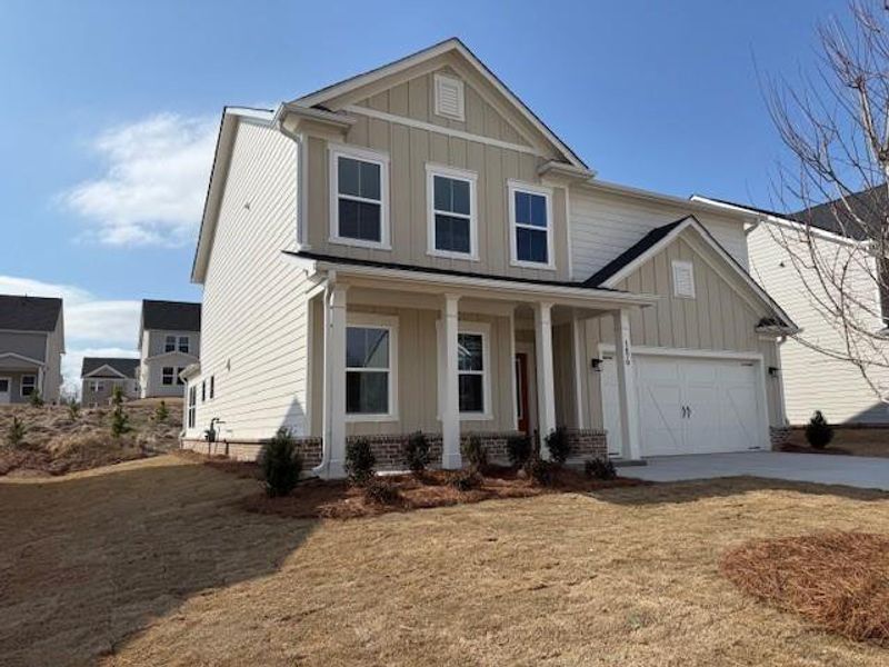 Front exterior of a new home in Berkeley Mill, Cumming, GA, highlighting curb appeal (Image 2). Front exterior of a new home in Berkeley Mill, Cumming, GA, highlighting curb appeal (Image 2).