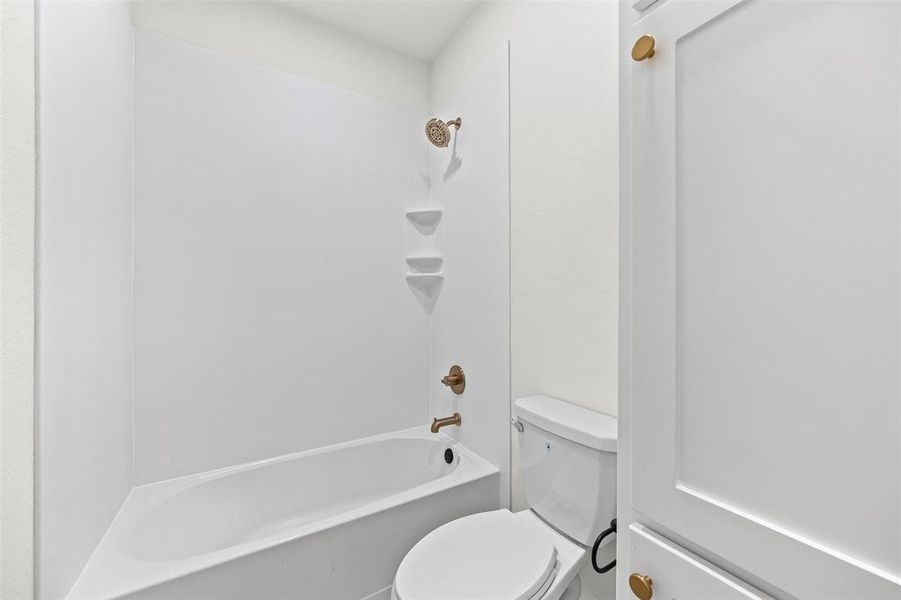 Bathroom with shower / bath combination and toilet Bathroom with shower / bath combination and toilet