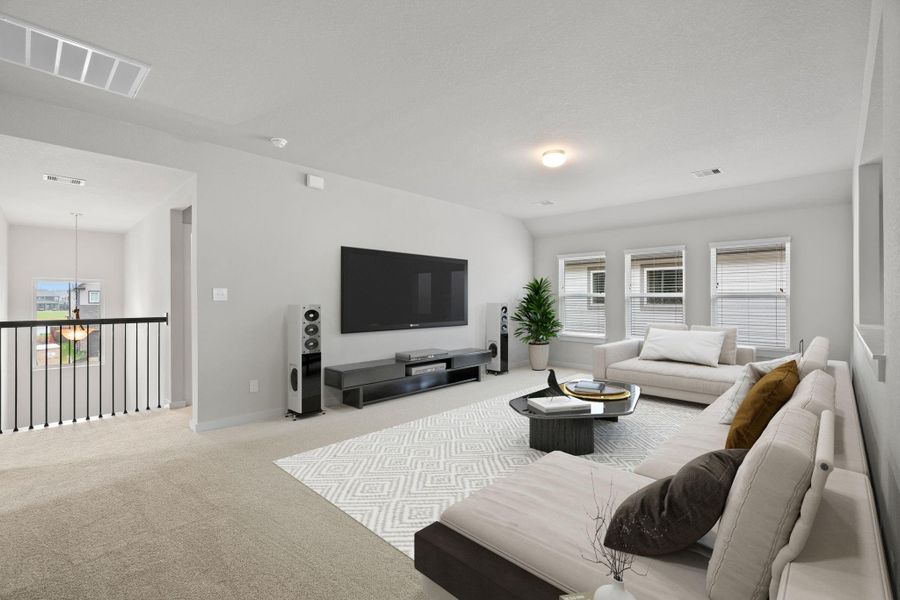 Upstairs can be used as game room or as additional living space.  Features plush carpet, high ceilings, custom paint and windows for plenty of natural light. Sample photo of completed home with similar floor plan. As-built interior colors and selections may vary.