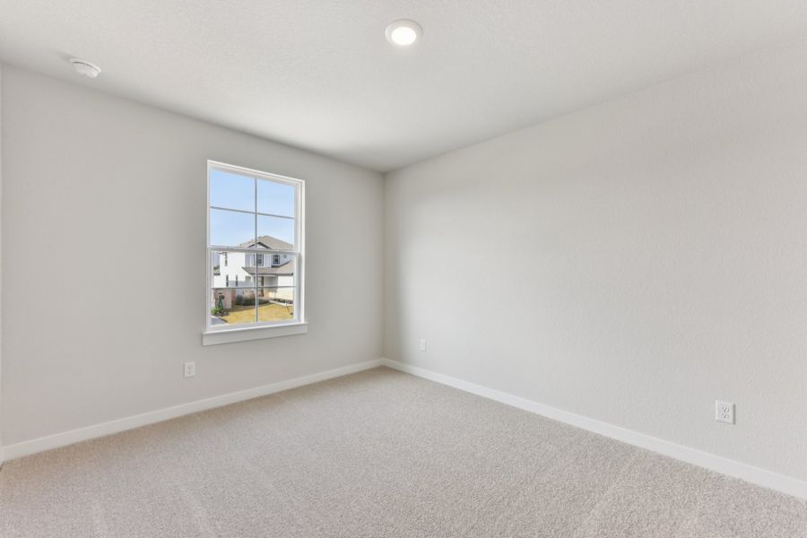 A room with a window and a carpet. A room with a window and a carpet.